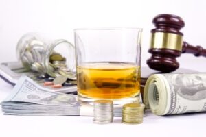 Drink driving concept: A judge's gavel, a glass of whiskey, and car keys.