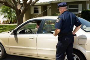 A police officer pulling over a motorist on the street.